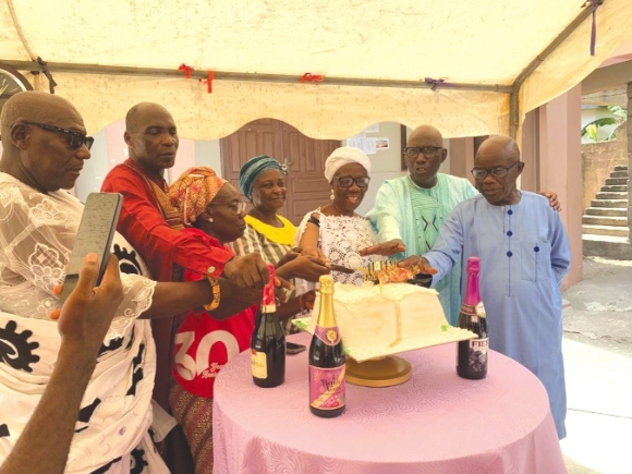 • Some members of the church cutting the anniversary cake Church of God Ghana celebrates 30 years of faith, service