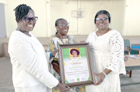 Mavis Osei Boateng (right), acting president of SLOPSA Kumasi Chapter,being supported by a member to  present the citation to Prof. Grace Nkansa Asante (left)