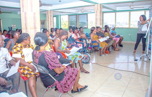 Patience Adiekeke Morrison (standing), Gender and Entrepreneurship Development Officer of the VTF Programme, speaking to the participants in the training
