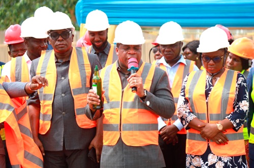 Rev. Dr Stephen Wengam (middle), General Superintendent of Assemblies of God, Ghana, praying before the sod cutting was done. INSET: Rev. Wengam performing the sod cutting to kick-start the project