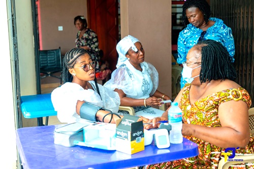 A church member (left) undergoing screening by medical personnel