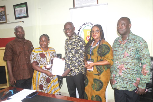 Juilet Akuamoah Boateng (2nd from left), Project Coordinator, World Child Cancer, presenting the shipment document to Dr Anthony Adofo Ofosu (middle), Deputy Director-General, GHS. With them are Emmanuel Ayire Adongo (left), Regional Coordinator, Sub-Saharan Africa, WCC; Dr Marion Okoh-Owusu (2nd from right), Director, Family Health Division, GHS, and Charles Owusu (right), Administrator, Family Health Division, GHS. Picture: ESTHER ADJORKOR ADJEI Juilet Akuamoah Boateng (2nd from left), Project Coordinator, World Child Cancer, presenting the shipment document to Dr Anthony Adofo Ofosu (middle), Deputy Director-General, GHS. With them are Emmanuel Ayire Adongo (left), Regional Coordinator, Sub-Saharan Africa, WCC; Dr Marion Okoh-Owusu (2nd from right), Director, Family Health Division, GHS, and Charles Owusu (right), Administrator, Family Health Division, GHS. Picture: ESTHER ADJORKOR ADJEI
