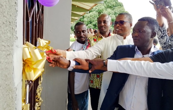 Rev. Fr Gordon Tawiah (2nd from right), Acting Rector of the school, being assisted by Williams Mensah (right), President of the 2000-year group and other group members to cut the tape to inaugurate the facility. Rev. Fr Gordon Tawiah (2nd from right), Acting Rector of the school, being assisted by Williams Mensah (right), President of the 2000-year group and other group members to cut the tape to inaugurate the facility.