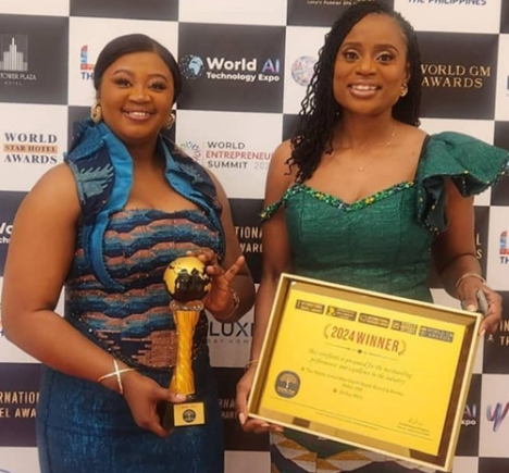 Jane Gyimah-Amoako(left), Executive Manager - Sales, Marketing & Business Development and Lolita Fiadjoe (right), Rooms Division Manager, Tang palace Hotel with an award trophy and a citation.