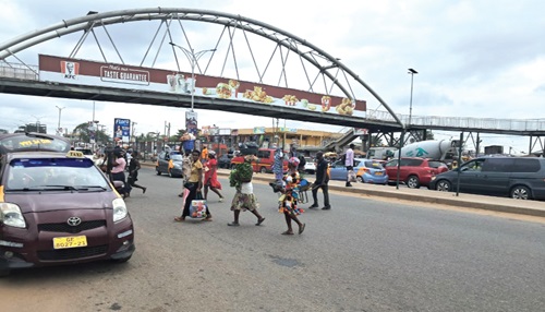 Scores of pedestrians abandon the Mallam Market footbridge and continue to jaywalk.