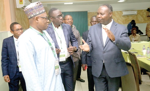 Dr Faka Nsadisa (right), Team Leader, OACMSA Programme Secretariat, interacting with Dr Tinni Halidon Seydou (left), Head of Regional Hydrometetrological and Climate Division, AGRNYMET-RCC