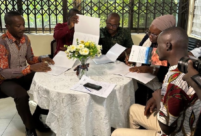 Partners signing document at the launch