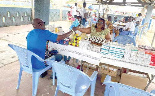 A Medical Officer of FHH (left) assisting a client during the exercise A Medical Officer of FHH (left) assisting a client during the exercise