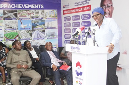 Lawuratu Musah-Saaka speaking at the press conference while Kojo Poku (left) and Osei Kyei-Mensah-Bonsu (right) and others, all seated, look on