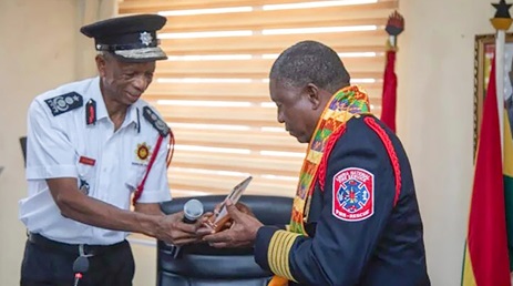Julius Kuunour (left) presenting a plaque to Col. Barvoul Warsuwah Julius Kuunour (left) presenting a plaque to Col. Barvoul Warsuwah