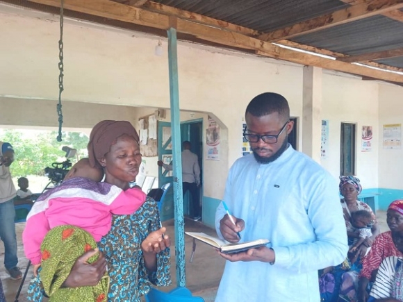 This reporter, Mohammed Fugu, interacting with mothers of malnourished children Karaga health facility