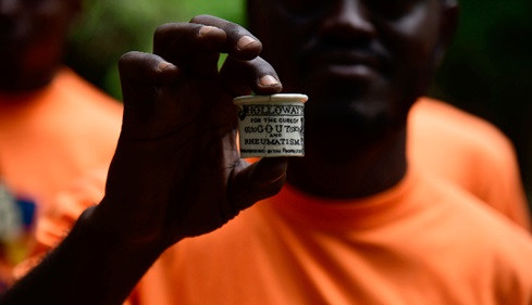 A volunteer  archaelogist showing a ceramic cup found during excavation  work at the Osu Castle in Accra