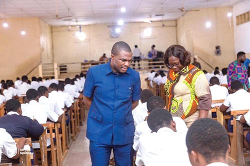  Dr Eric Nkansah (right), Director-General of GES, joined by Rejoice Accolor, Headmistress of Labone Senior High School, observing a candidate writing the examination