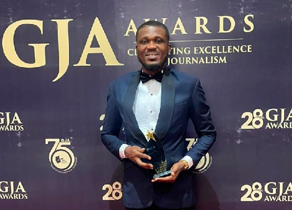 Emmanuel Bruce with his award Graphic Business reporter wins Best Business and Economic Journalist