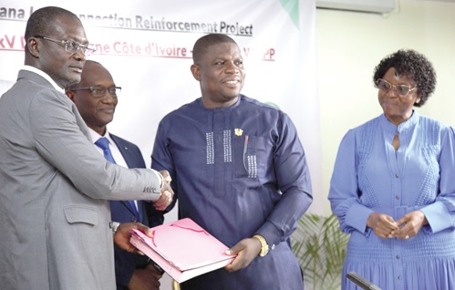 Richard Gyan-Mensah, (right), Deputy Minister of Energy, exchanging the signed document with Jean- Baptiste Aka K. Kadjo (left), Deputy Minister of Energy of Cote d'Ivoire. With them is Abdoulaye Dia, General-Secretary of WAPP