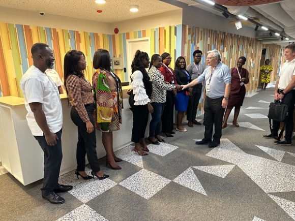 Daniel Julien (right), CEO and Founder, TP interacting with some workers at the new office of the company in Accra. Govt, TP tackles youth unemployment with 5,000 digital jobs