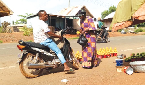  Memunatu Nurideen, a mango seller, attending to a  customer 
