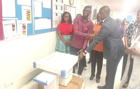 Nana K. Owiredu, Community Relations Officer of Ghana Gas, handing over the device to Dr Ralph Armah, Medical Director of the Greater Accra Regional Hospital