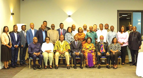 Joseph Bukari Nikpe (in smock and seated), Minister of Transport, with participants after the breakfast meeting 