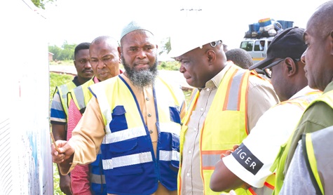 Sheikh Aminu Abubakar (left), Eastern Regional GHA DirectAor, making a presentation to Governs Agbodza (3rd from right), Minister of Roads and Highways Sheikh Aminu Abubakar (left), Eastern Regional GHA DirectAor, making a presentation to Governs Agbodza (3rd from right), Minister of Roads and Highways