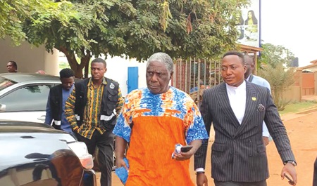 Ademan Tetteh (2nd from right), one of the directors of the Institute, being escorted by two security personnel Ademan Tetteh (2nd from right), one of the directors of the Institute, being escorted by two security personnel