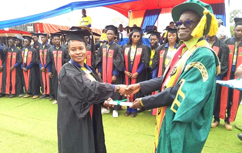 Prof. Daniels Obeng-Ofori (left), Vice Chancellor of the Catholic University of Ghana, presenting a certificate to one of the female graduates Prof. Daniels Obeng-Ofori (left), Vice Chancellor of the Catholic University of Ghana, presenting a certificate to one of the female graduates