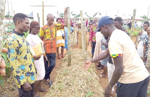 One of the Technical Field Officers, schooling the farmers to prepare mulching to sustain soil moisture