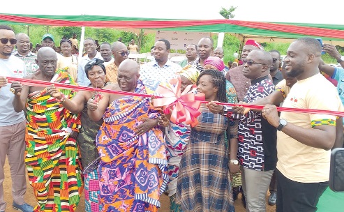 Nana Osei Kufour II (2nd from left), Gyaasehene of the Duayaw Nkwanta Traditional Council, being assisted by Kwadwo Boakye Donkor (right), Project Lead of the EWS-KT, and some dignitaries to inaugurate the demonstration site