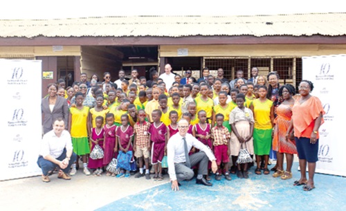 Some managers of Kempinski Hotel Gold Coast City with pupils and teachers of the basic school
