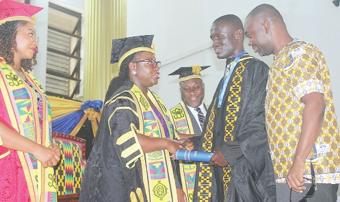 Prof. Nana Aba Appiah Amfo (left), Vice Chancellor,  UG, congratulating Malik Alhassan (2nd from right), a graduand with special needs. Picture: ERNEST KODZI
