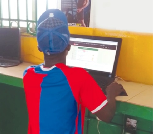 A young boy at a betting centre A young boy at a betting centre