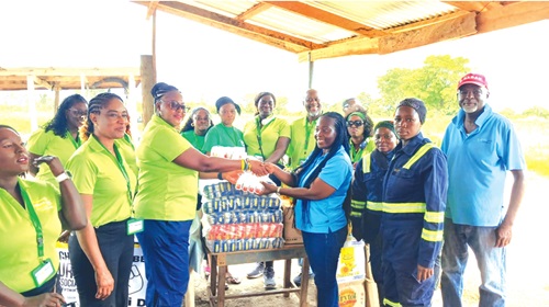 Gloria Opoku Dartey (3rd from left), President of the association, presenting food items to Rosemond Anim-Somuah (3rd from right), Director of Human Resources and Administration of Agromite Limited