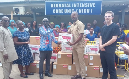 Dr Akwasi Agyeman Ahmed (2nd from right), Chief Executive Officer, Africa Eye Imaging Centre, presenting the equipment to Dr Boateng Nimako, Head of Quality Assurance, KATH. Looking on is Hanks Wallace (right), a representative of Zero Blind Babies, and other officials