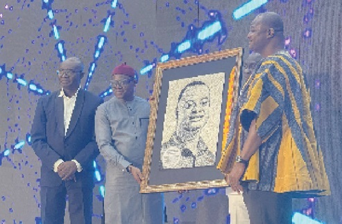 Professor Raymond Atuguba (right) receiving the portrait from Prof. Peter Atudiwe Atupare (2nd from left), the new Dean of the University of Ghana School of Law. Looking on is Prof. Daniel Frimpong Ofori (left), the acting Director of the University of Ghana Academic Quality Assurance Unit