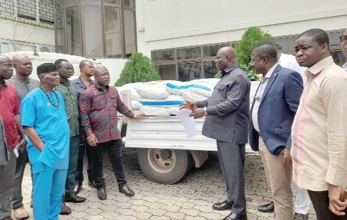 Eric Opoku (3rd from right), Minister of Food and Agriculture, presenting the fertilisers to the regional Ministers and Members of Parliament