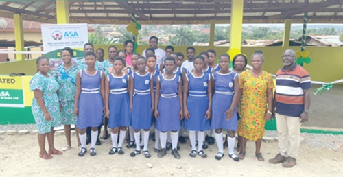 Rev. Happy Anyana (right), Headteacher of the Presbyterian New Town JHS, with some staff of the Asamankese Area of ASA Savings and Loans Limited and some pupils of the school Rev. Happy Anyana (right), Headteacher of the Presbyterian New Town JHS, with some staff of the Asamankese Area of ASA Savings and Loans Limited and some pupils of the school