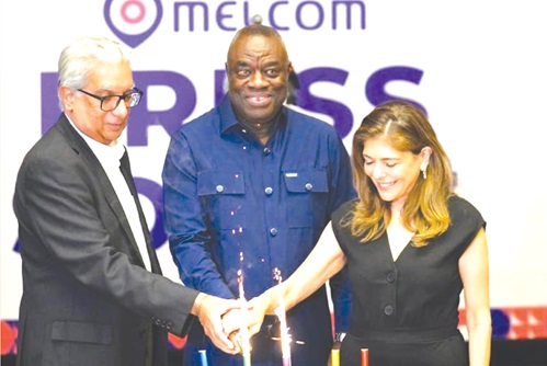 Ramesh Sadhwani (left), MD of Melcom Group, Sonya Sadhwani, Group Executive Director of Melcom, and Dr Ibrahim Mohammed Awal (right),  Communications and Business Strategy Consultant, Melcom Group, cutting the cake at the event