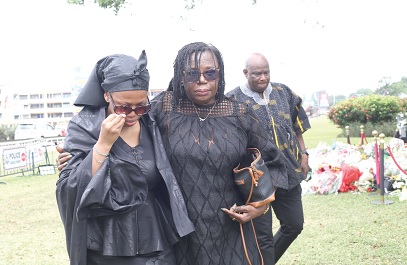 Squadron Leader Peter Bafemi Anala’s wife with her family on their way to lay flowers for the departed. Picture: BENEDICT OBUOBI Squadron Leader Peter Bafemi Anala’s wife with her family on their way to lay flowers for the departed. Picture: BENEDICT OBUOBI