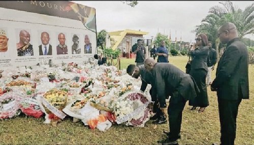 Richard Kwame Asante (2nd from right), Board Chairman, MIIF, being assisted to lay the wreath while Justina Nelson (2nd from right), Chief Executive Officer, MIIF, and David Awuah (right), Chief Finance Officer, MIIF, look on Richard Kwame Asante (2nd from right), Board Chairman, MIIF, being assisted to lay the wreath while Justina Nelson (2nd from right), Chief Executive Officer, MIIF, and David Awuah (right), Chief Finance Officer, MIIF, look on