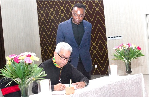 Ramesh Sadhwani, Group Managing Director, Melcom Group of Companies, signing the book of condolence. With him is Francis Sam, Group General Manager of the company. Picture: SAMUEL TEI ADANO