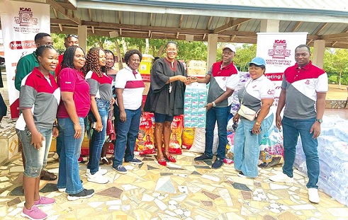 Joshua Lomotey (right), Chairman of the Kascity District Society of the Institute of Chartered Accountants, Ghana, handing over the items to Nana Ntow Amoah Klordey II, the Founder of Royal Seed Home