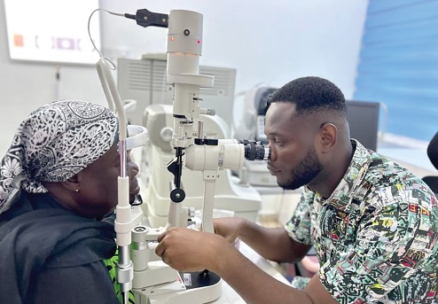 Dr Alphaeus Asamoah Amoasi, Ophthalmologist of the EUH, checking the eyes of a patron Dr Alphaeus Asamoah Amoasi, Ophthalmologist of the EUH, checking the eyes of a patron