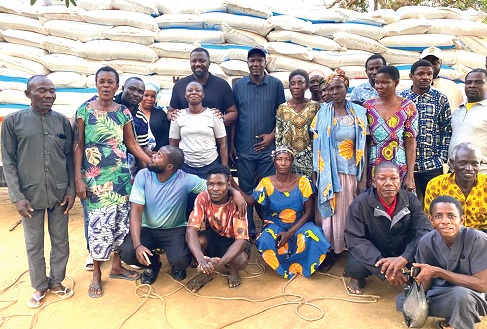 John Setor Dumelo (arrowed), Deputy Minister of Food and Agriculture, and Maxwell Lukutor (middle, back row), Member of Parliament for South Tongu, with some of the farmers 