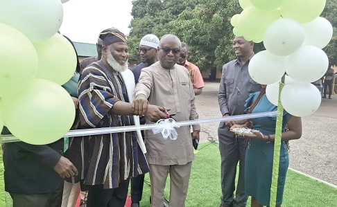 Naa Seidu Zakari Abu (in smock), acting Director of Survey and Mapping Division of the Lands Commission, with other officials to cut the tape for the launch of the CORS