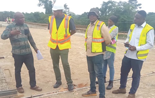Samuel K. Ofori Larbi (left), Managing Director, Asabea Engineering Limited, interacting with some workers during an inspection of the bridge Samuel K. Ofori Larbi (left), Managing Director, Asabea Engineering Limited, interacting with some workers during an inspection of the bridge