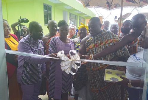 Albert Kusi-Appiah (left) with Dr Nana Adoma Owusu-Nyamekye (middle), his wife, assisting Nana Amponsah Kwaah (right), the Asantehene’s representative, to cut the tape to inaugurate the facility