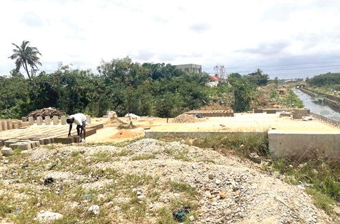 A construction labourer laying blocks close to the Labadi-bound section of the road
