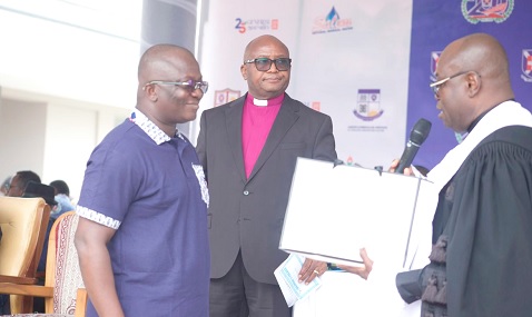 Rt Rev. Dr Abraham Nana Opare Kwakye (right), Moderator, Presbyterian Church of Ghana (PCG), presenting a gift of appreciation to Dr Bryan Acheampong (left), MP,  Abetifi, for his immense support to the church. Looking on is Rev. Dr Godwin Nii Noi Odonkor, Clerk of the General Assembly, PCG