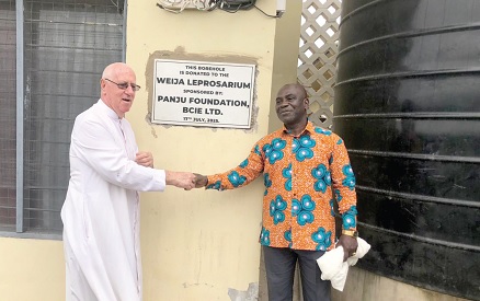Rev. Fr. Andrew Campbell (left), founder of the leprosarium,  thanking Kingsley Asiedu Koranteng, Regional Manager of BCIE, after the donation