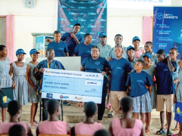 Caption: Gifty Annor-Sika Asantewah (4th right), Country representative, KeyToMarkets International presenting a dummy cheque to Francis Bodzona Kom Intensify education on digital finance for job creation — KeyToMarkets Country Rep